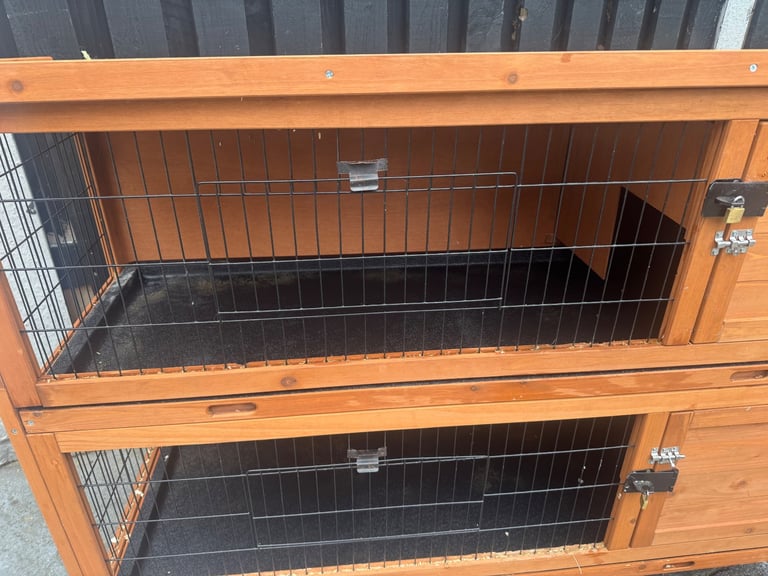 Animal hutch with sliding trays 