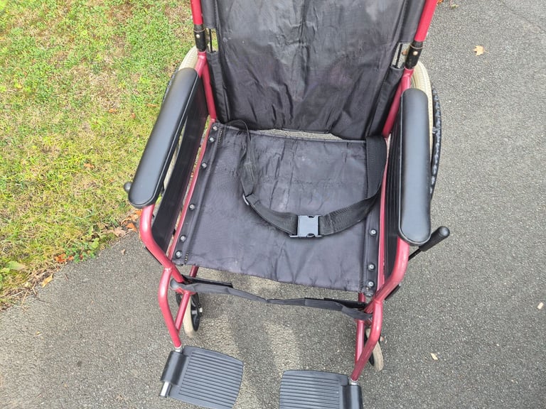 Self propel wheelchair. Brakes on handle. Lap belt. Wheel chair