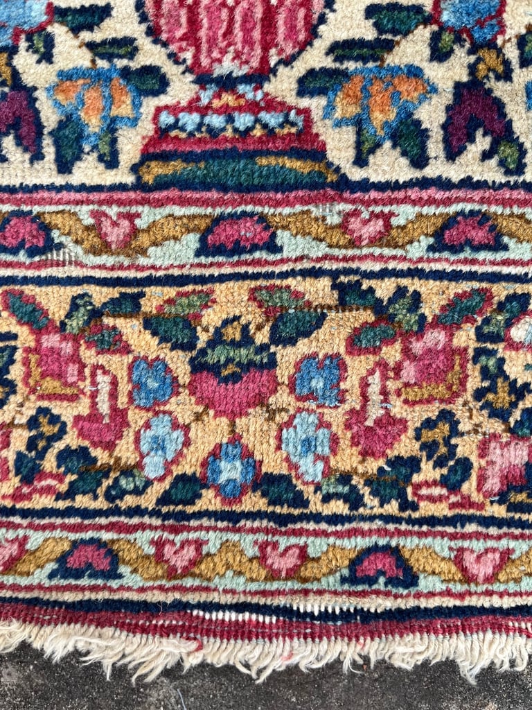 A pair of Antique Kirman mats 