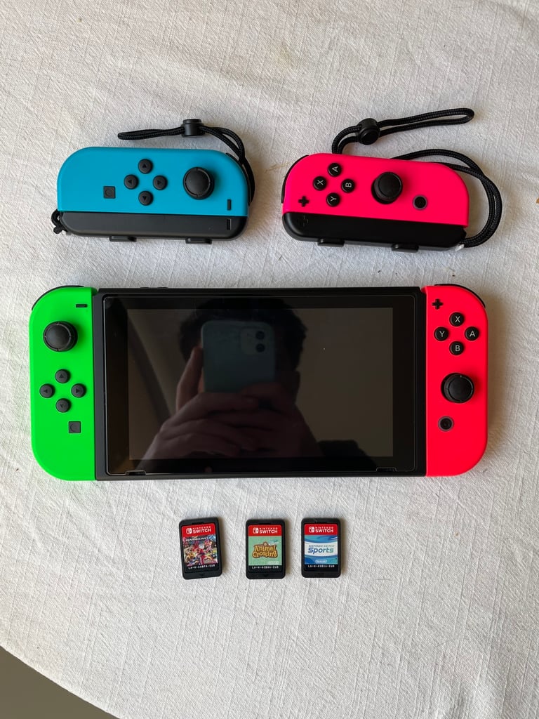 Nintendo Switch plus 2 extra controllers and 3 games