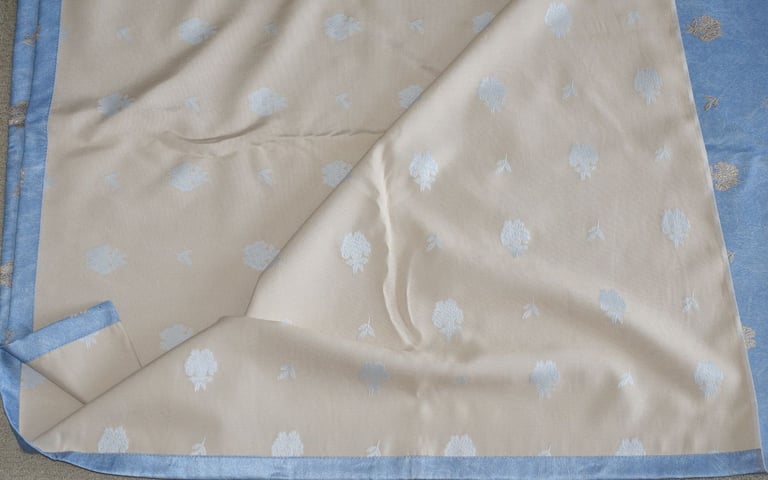 Pair of curtains, light blue. Each is 145 x 210 cm. Unlined. New, unused. 