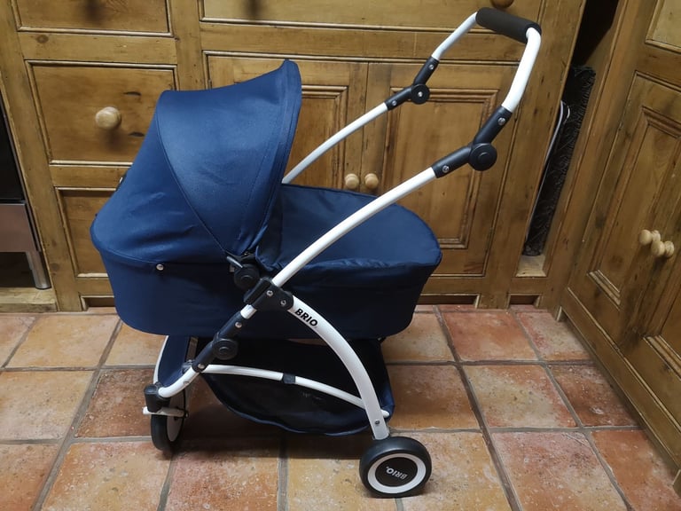 Brio Spin luxury toy pram for dolls & soft toys. Navy blue. Adjustable handle. Great used condition.