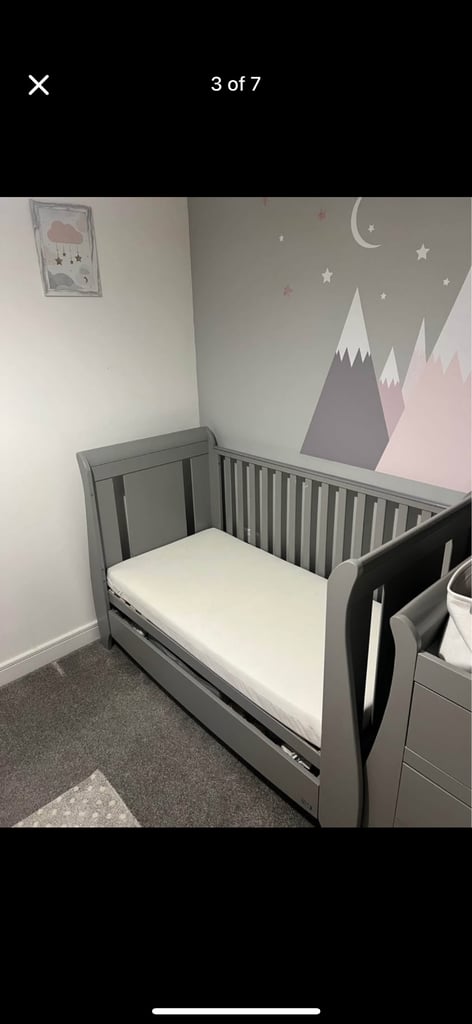 Grey cot bed with mattress available 