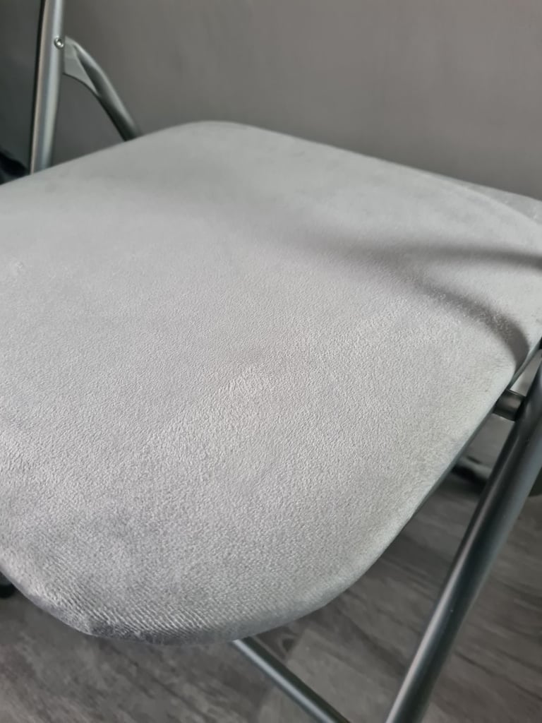 Grey foldable chair.