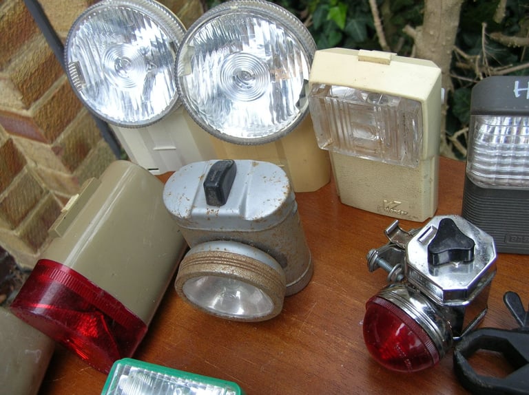 Collection of vintage front and rear bicycle lights.