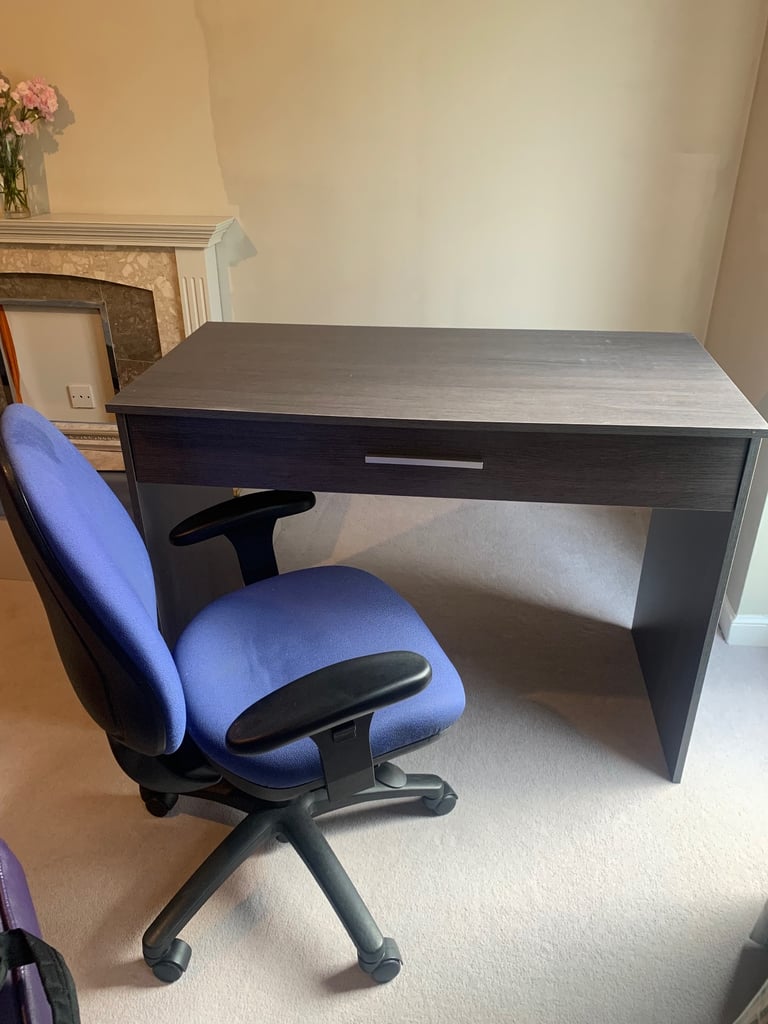 Grey office desk with drawer and office chair.