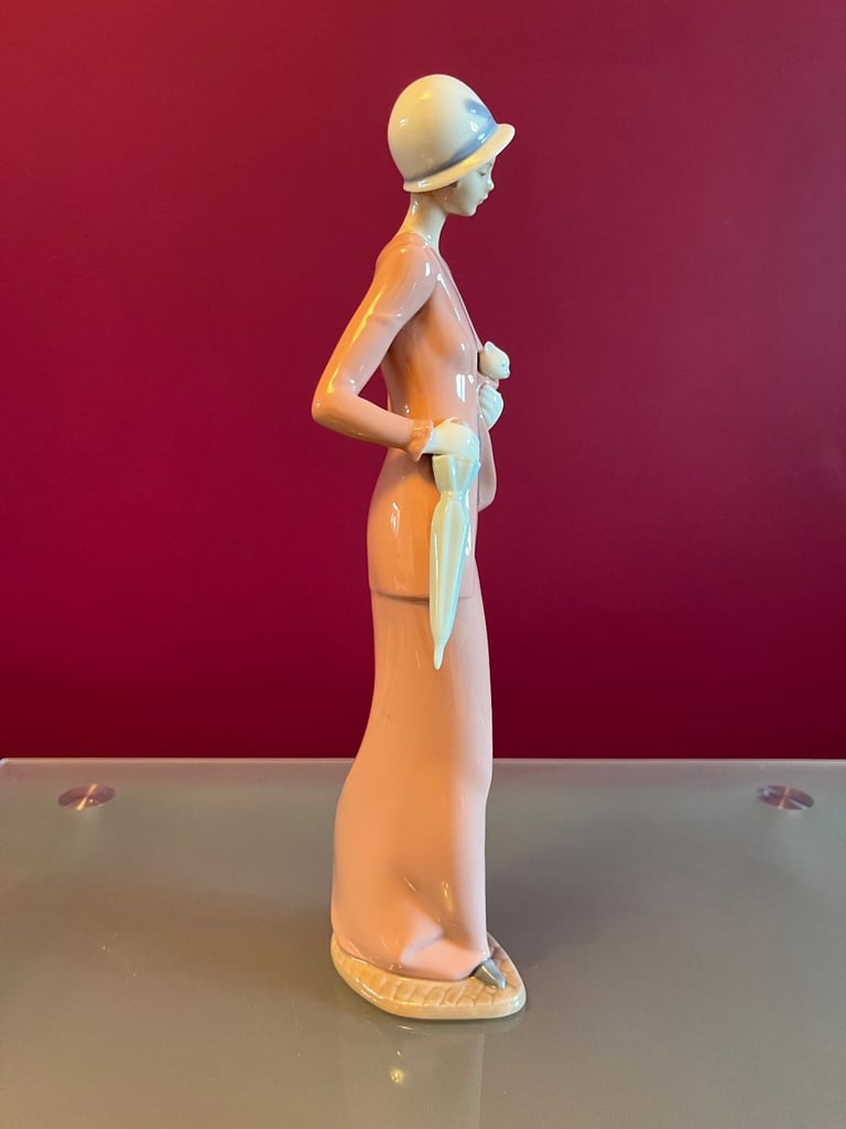 NAO Figurine - Woman, in 1920s outfit, carrying a cat & umbrella