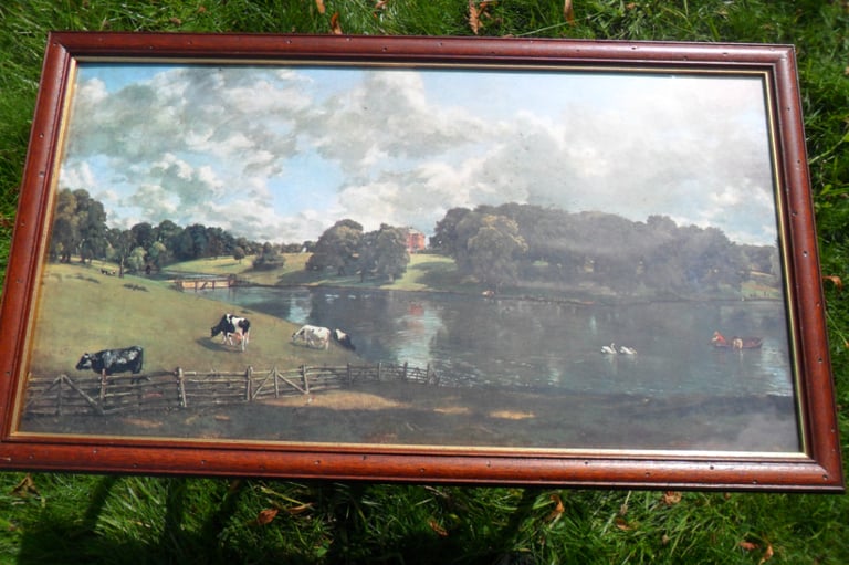 image for Glass framed picture of country scene.River , bank cows swans people.