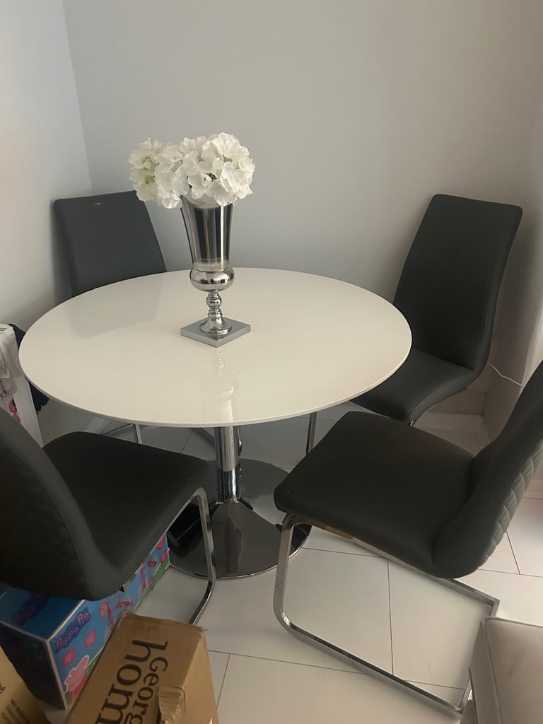 White high gloss and chrome table and chairs with grey leather chairs 