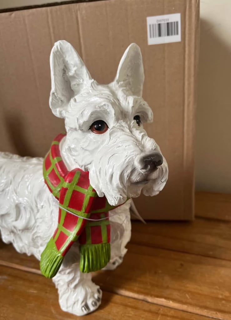 White resin Westie dog ornament wearing a scarf. New in box  Size height 26cm width 31cm depth 14 cm