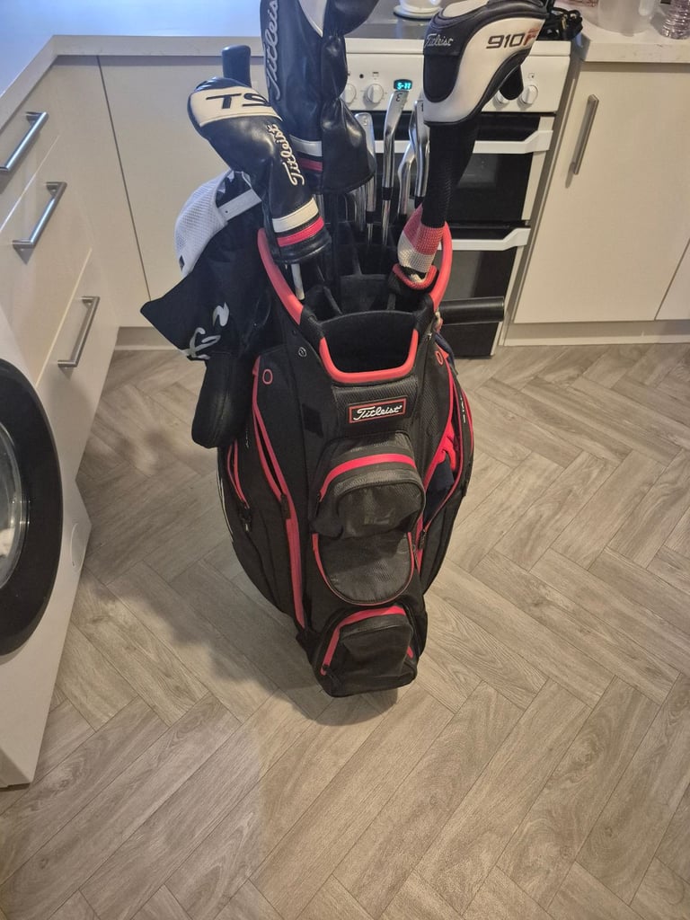 Full set titleist irons,driver, 3 wood, hybrid, mizuno rusty wedges and titleist bag 