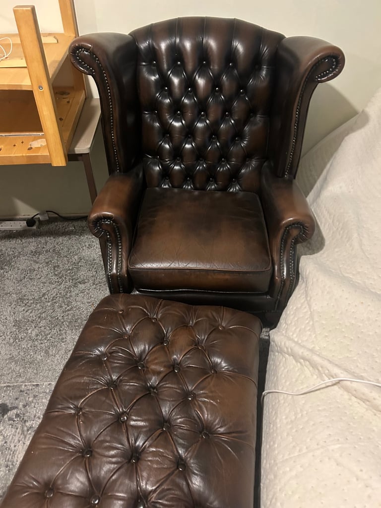 Brown leather armchair and footstool