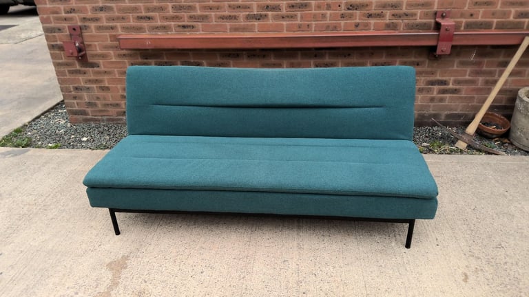 green 2 seater sofa that folds down to be a sofa bed 