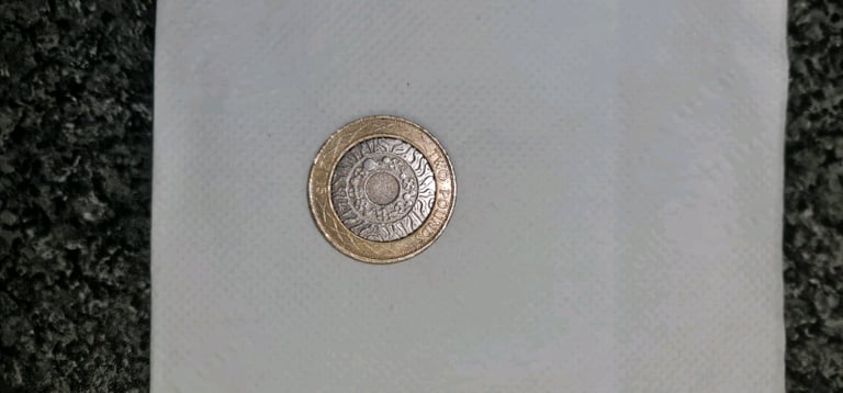 £2 coin standing on the shoulders of a giant 