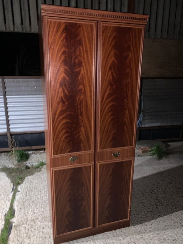 image for Elegant wooden wardrobe with decorative handles.