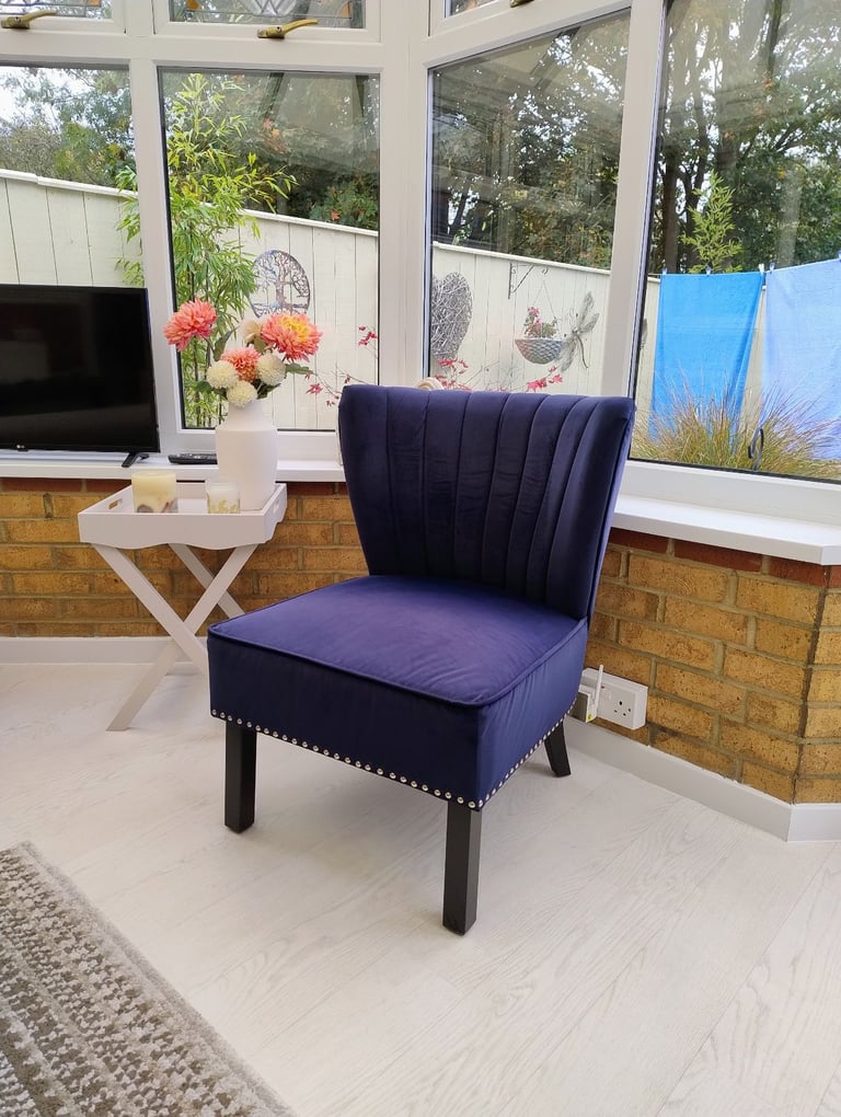A Velvet  material chair in a rich Royal Blue colour 
