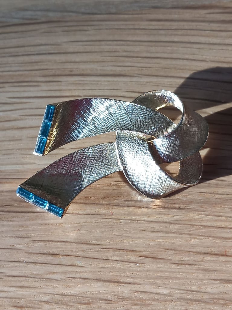 image for Gold coloured knot brooch with 3 baguette style turquoise cut glass stones, great gift idea