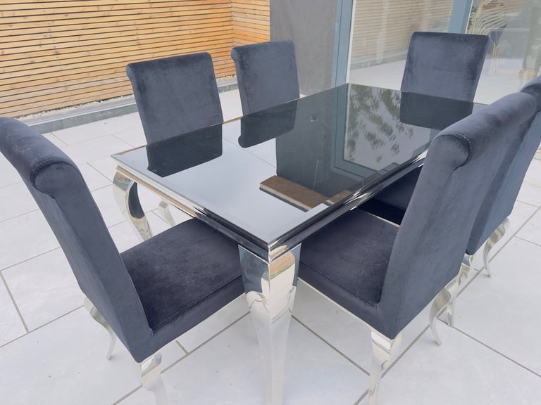 DINING TABLE AND 6 CHAIR SET. STATEMENT PIECE STYLISH CHROME WITH BLACK GLASS