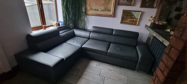 Grey leather corner sofa bed with storage