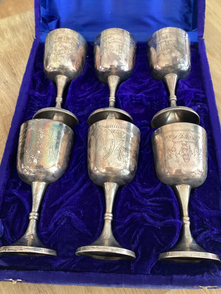 image for Silver coloured metal goblets in display case.