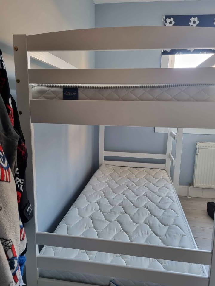 White wooden framed bunk beds with mattresses