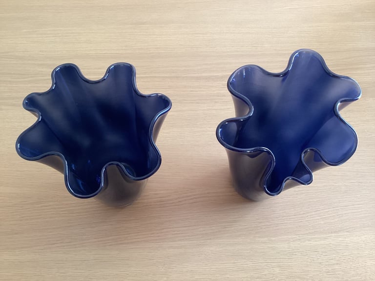 A pair of blue glass flower vases. 