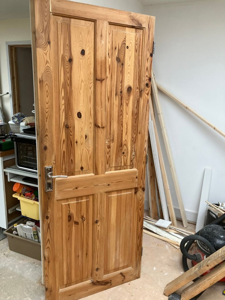 solid pine 4 panel door with silver coloured handle 