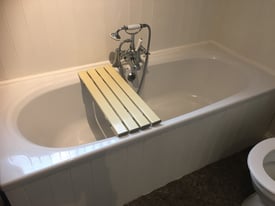 Slatted bath board assists to shower over bath or enter without step
