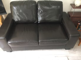 Two seater sofa in leather effect material. 