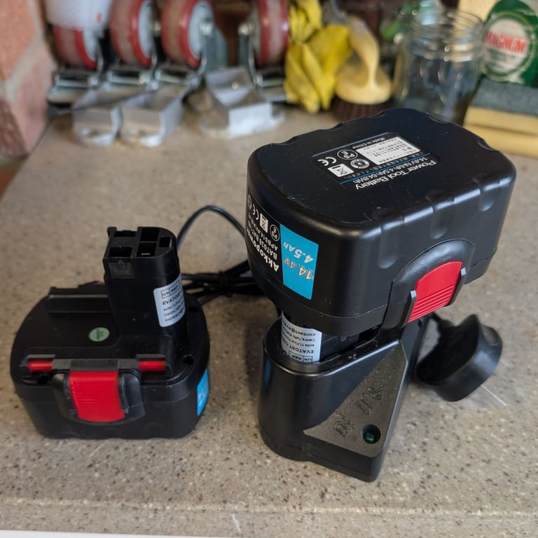 Two Bosch power tool batteries and charger 