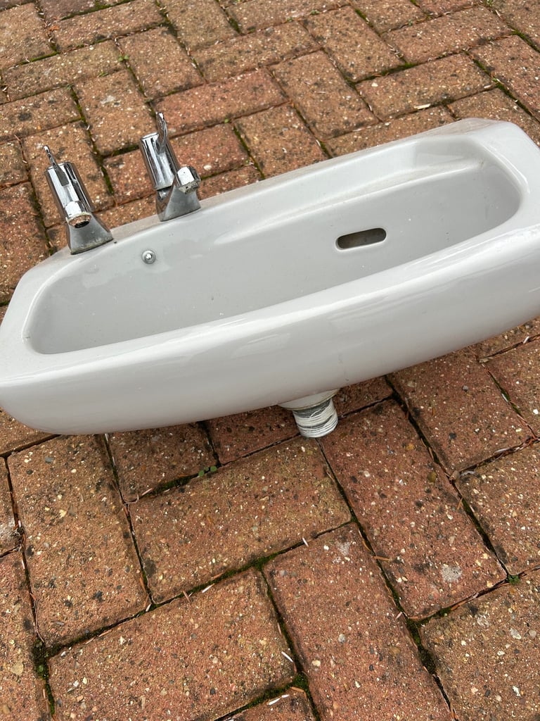 Small grey cloakroom basin sink with taps