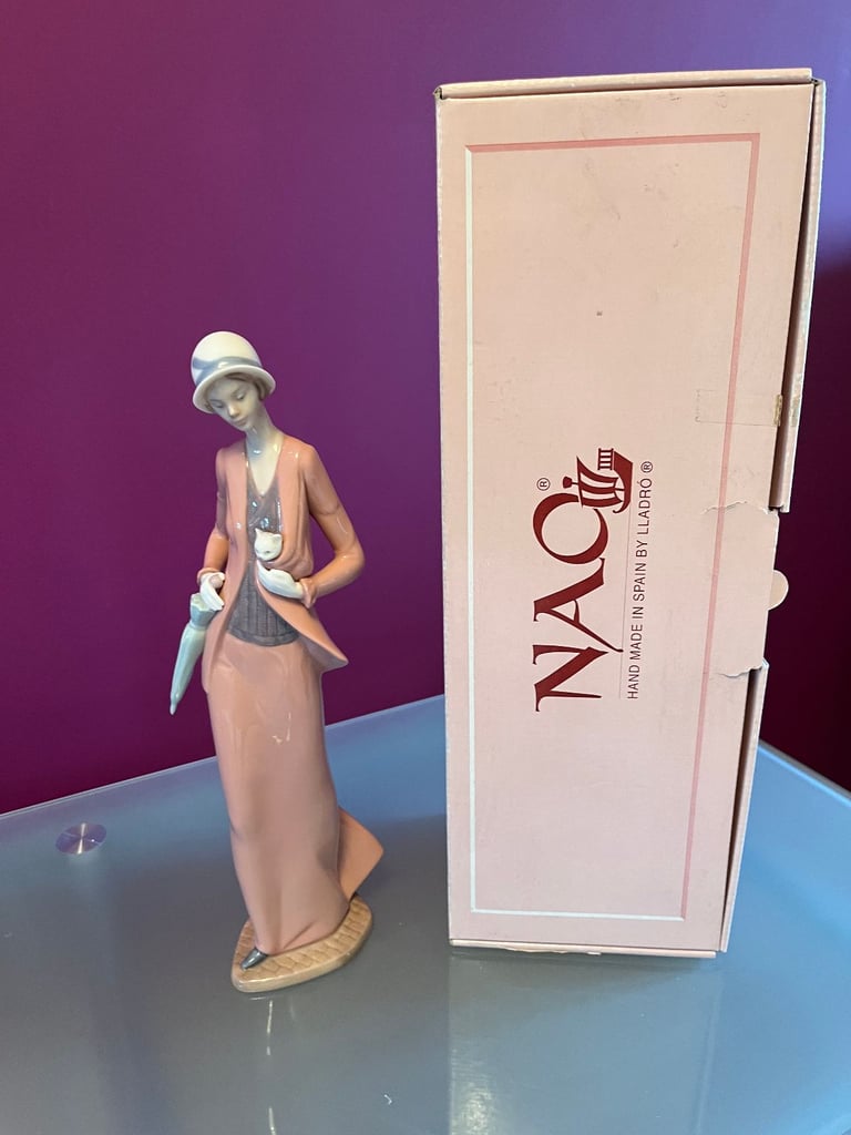 NAO Figurine - Woman, in 1920s outfit, carrying a cat & umbrella