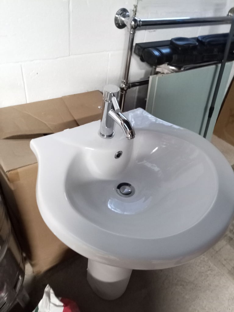 Bathroom sink with taps and push plug