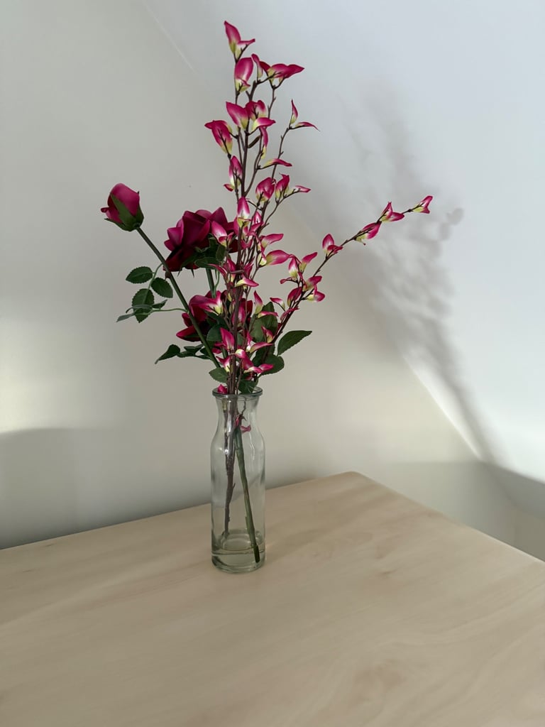 Beautiful glass vase with pink artificial flower arrangement in like new condition