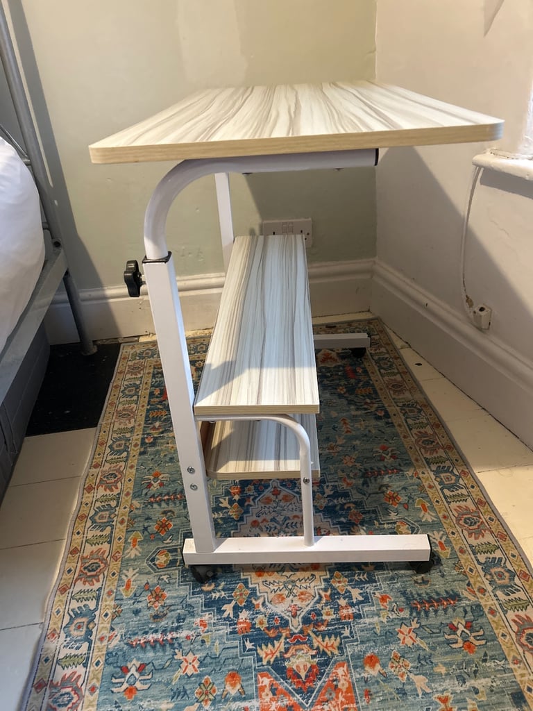Adjustable height desk with wheels and shelves