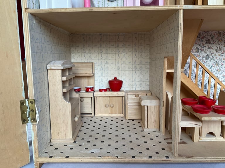 Handmade wooden dolls house with furniture and family