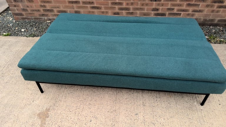green 2 seater sofa that folds down to be a sofa bed 