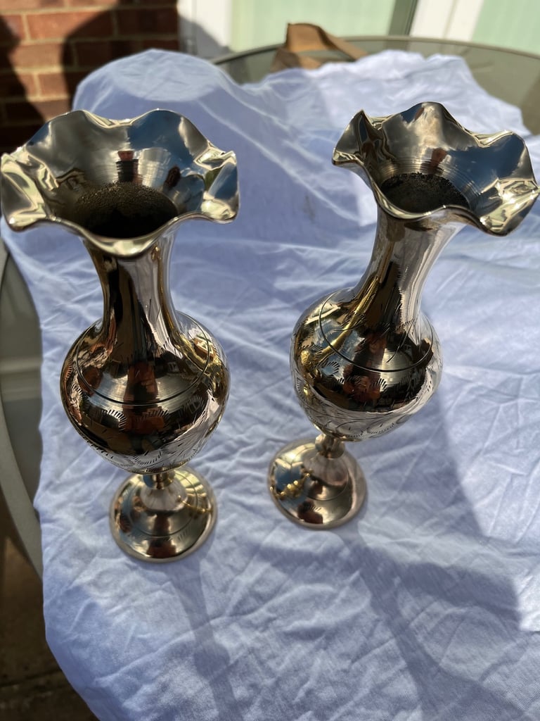 A pair of brass Indian etched vases