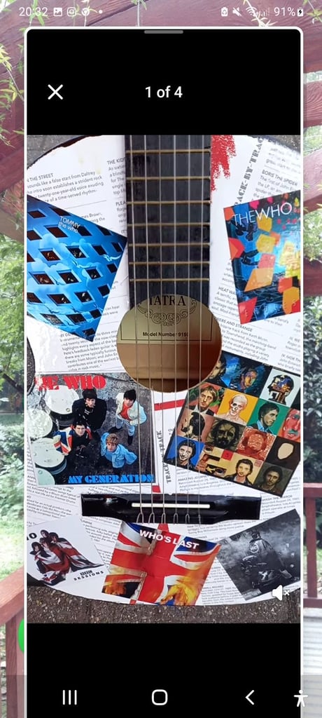 Adult guitar decorated with pictures of the Who, used, still playable 