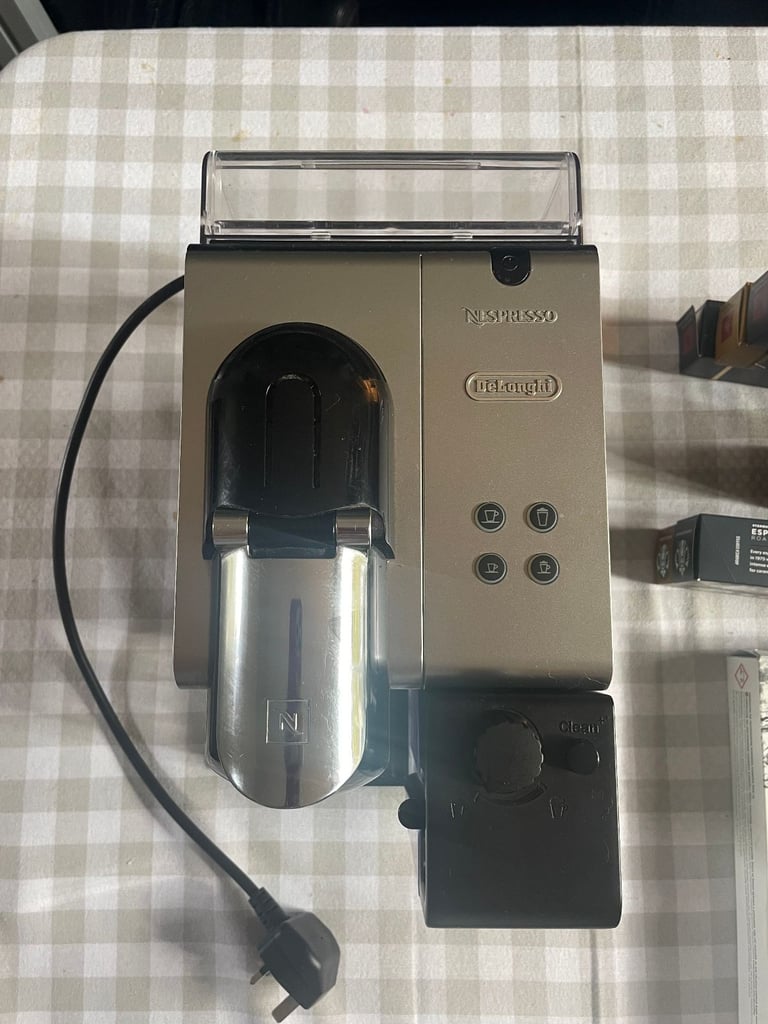 Nespresso DeLonghi coffee machine + milk frother + pods + stand
