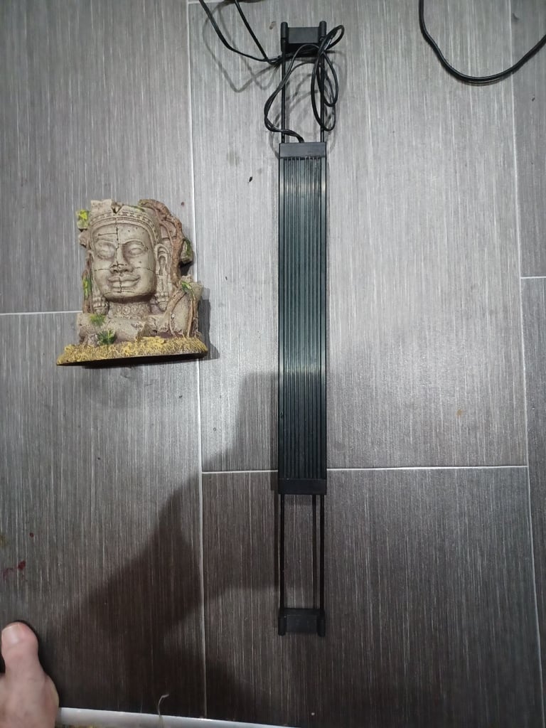 Fluval professional LED light, very low energy. Comes with Buddhist or Angkor Wat water feature