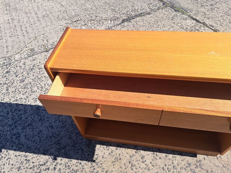 shelving unit in light brown wood with long drawer at the top 