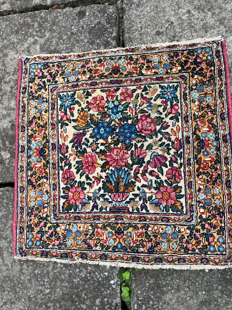 A pair of Antique Kirman mats 