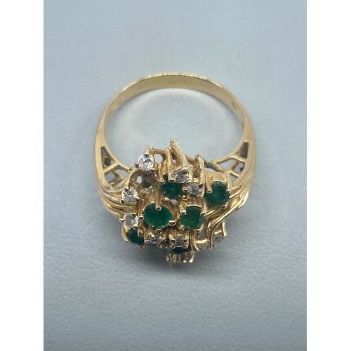 A 14ct yellow gold diamond & emerald dress ring