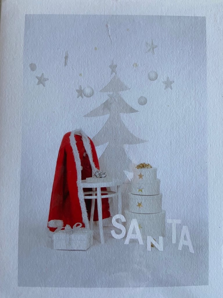 Christmas Card showing Santa’s red coat against white background