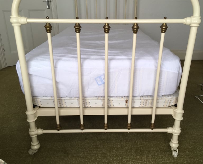 Vintage French brass & cream cast iron single bed on brass & china castors 