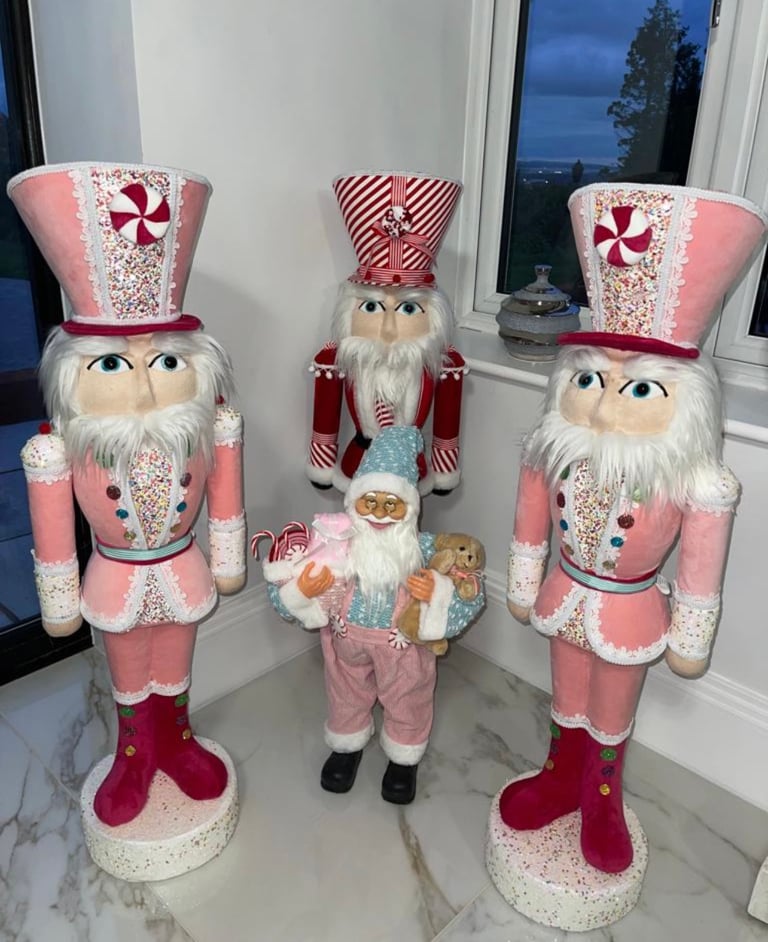 2 pink nutcrackers 1 red nutcracker and 1 pink Santa 