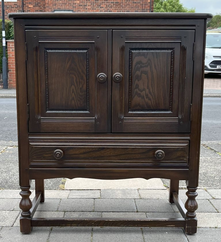 AN ERCOL CREDENCE CUPBOARD