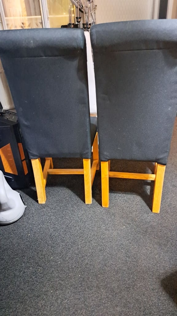 Two black solid chairs. 