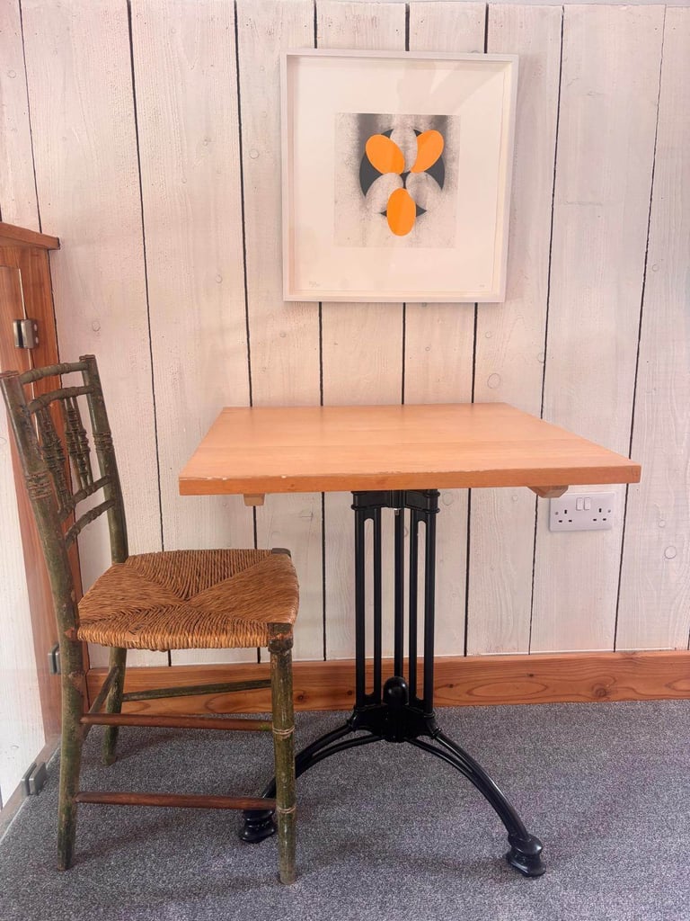 Eleven lovely cafe style tables with wooden tops and vintage style metal bases.